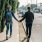 Couple walking down a sidewalk on a sunny day