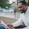 person sitting outside reading a book